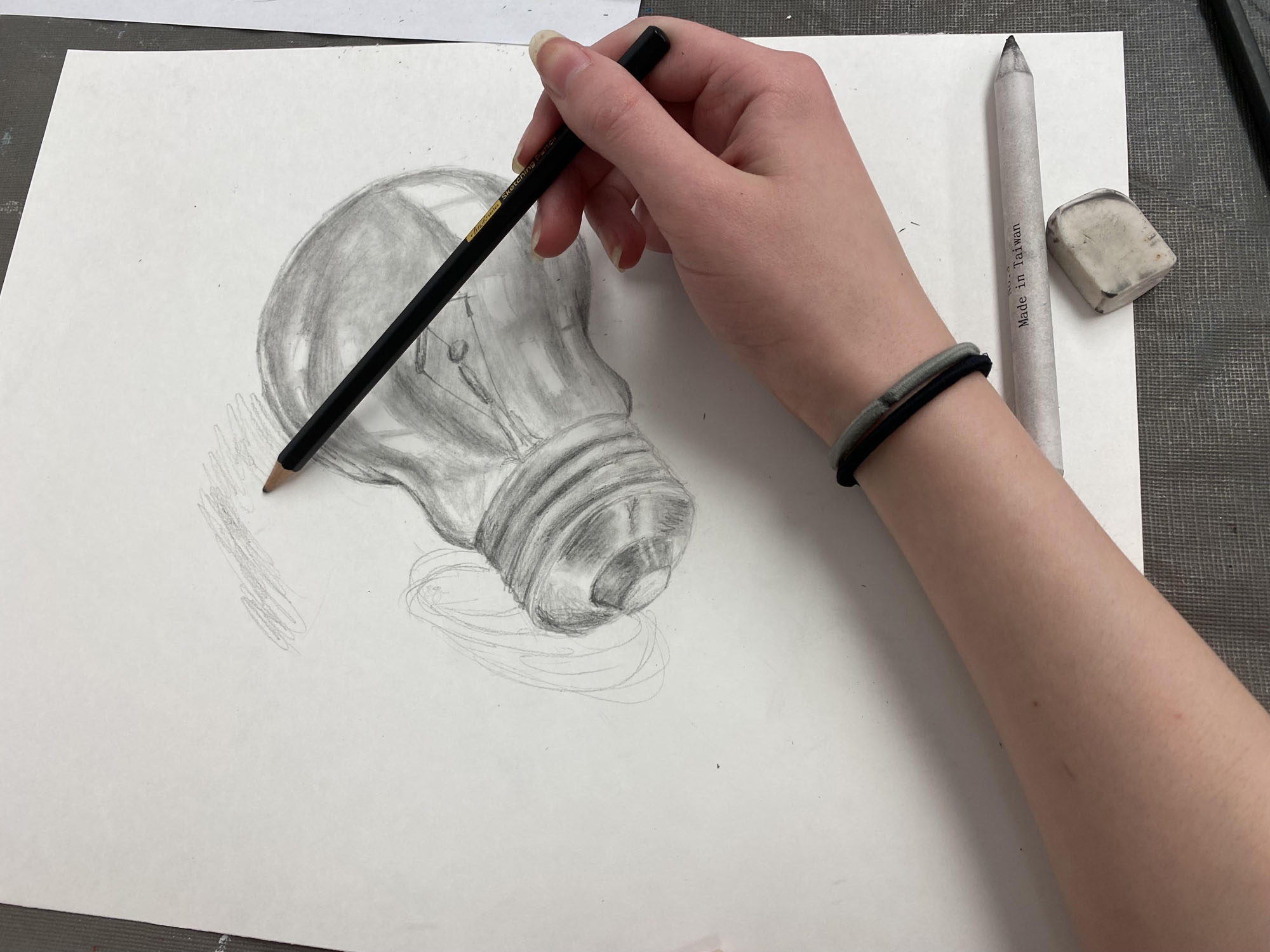 Student showing off their drawing.